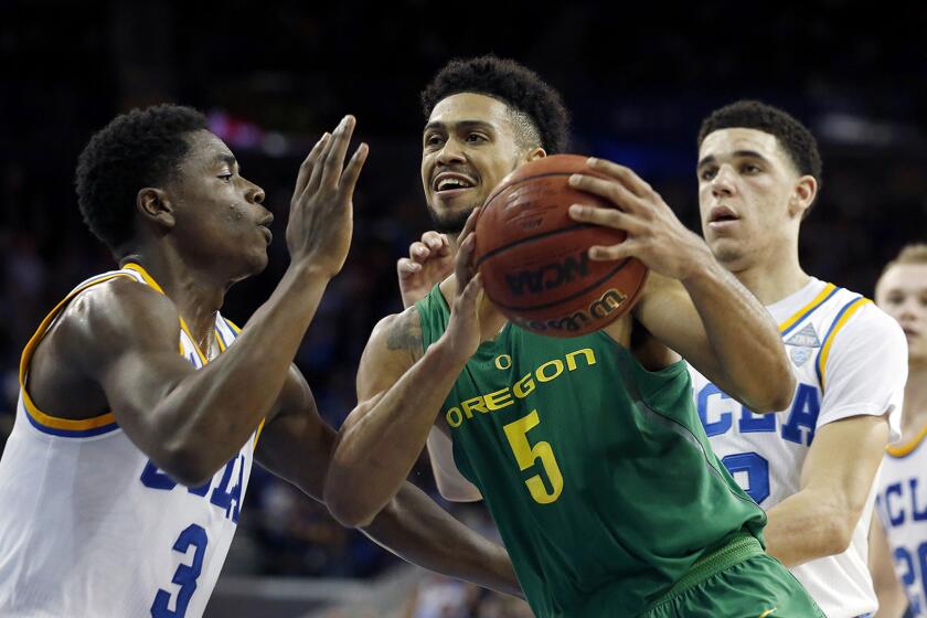 Oregon guard Tyler Dorsey (5) drives to the basket against UCLA guards Aaron Holiday (3) and Lonzo Ball during the second half.