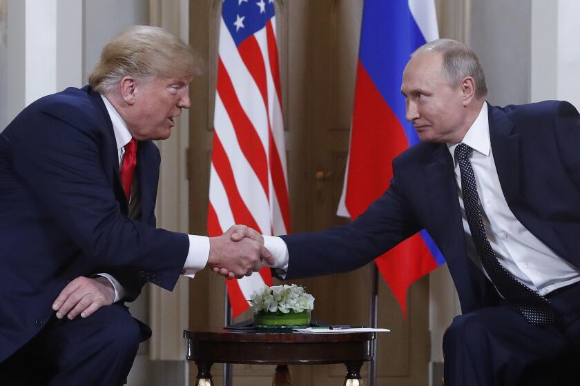 U.S. President Donald Trump, left, and Russian President Vladimir Putin, right, shake hand at the beginning of a meeting at the Presidential Palace in Helsinki, Finland, Monday, July 16, 2018. (AP Photo/Pablo Martinez Monsivais)