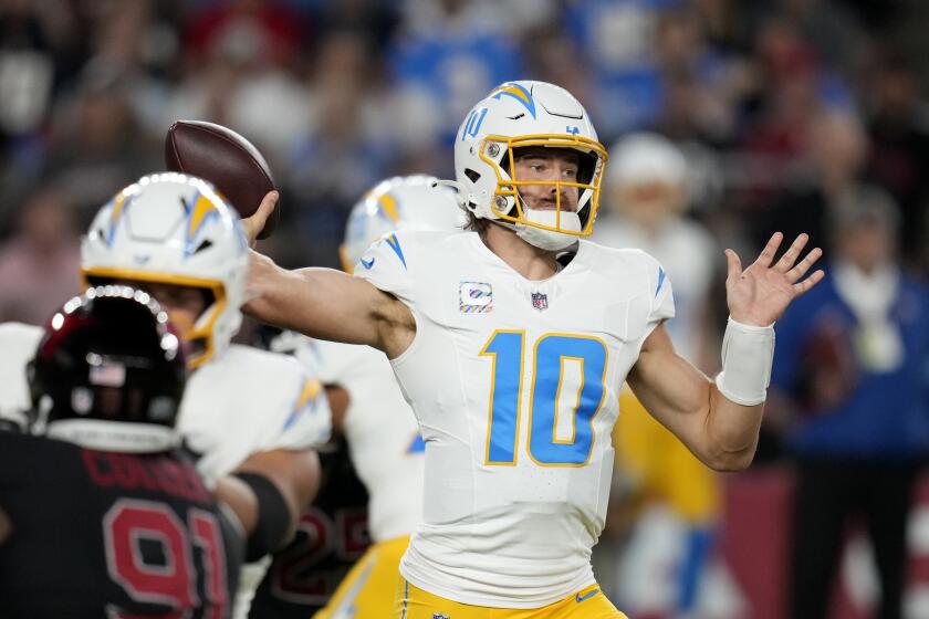 Los Angeles Chargers quarterback Justin Herbert (10) throws a pass during the first half of an NFL football game against the Arizona Cardinals, Monday, Oct. 21, 2024, in Glendale Ariz. (AP Photo/Ross D. Franklin)