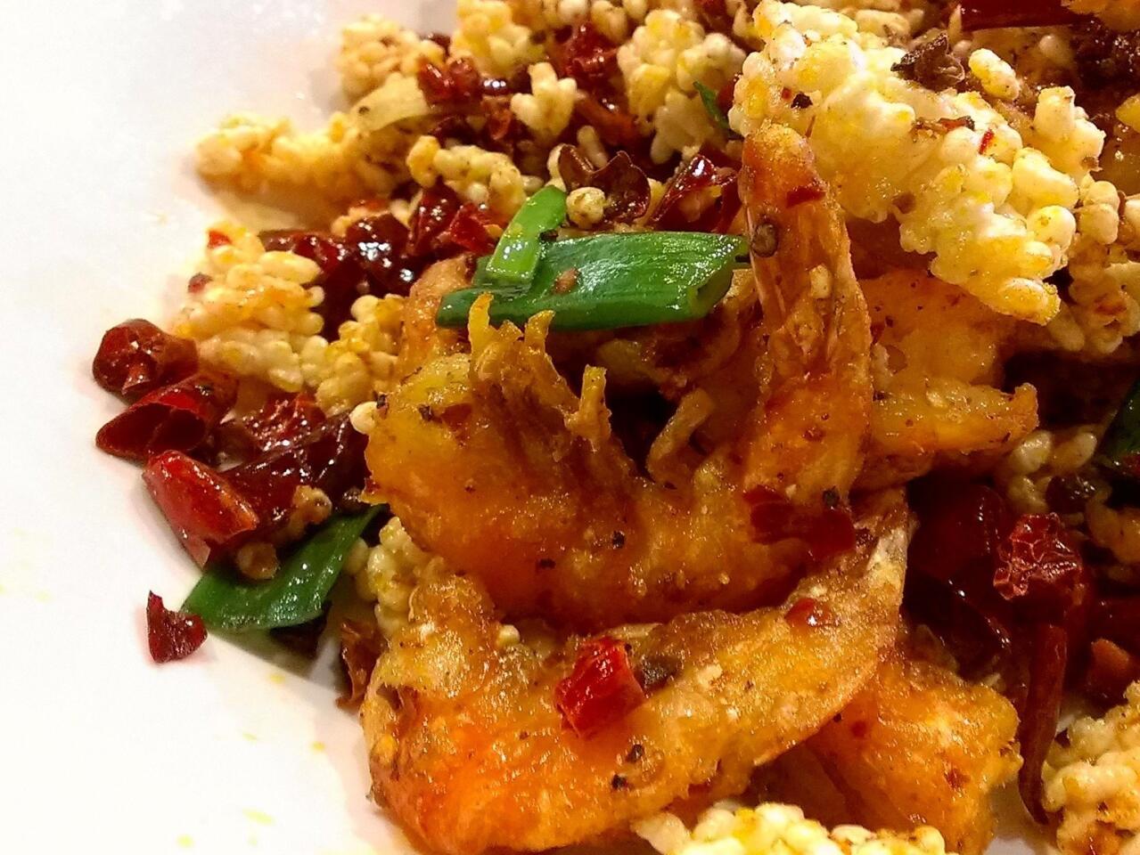 The spicy shrimp with sizzling rice at Chengdu Taste is a platter of deep-fried shrimp with clusters of puffed rice, green onions, chiles and garlic.
