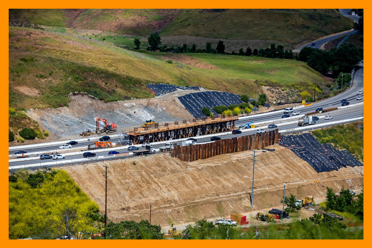 An aerial view of a bridge being built over a freeway