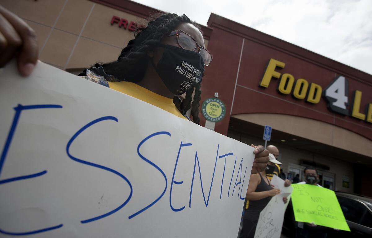 Grocery store workers demonstrate in August.