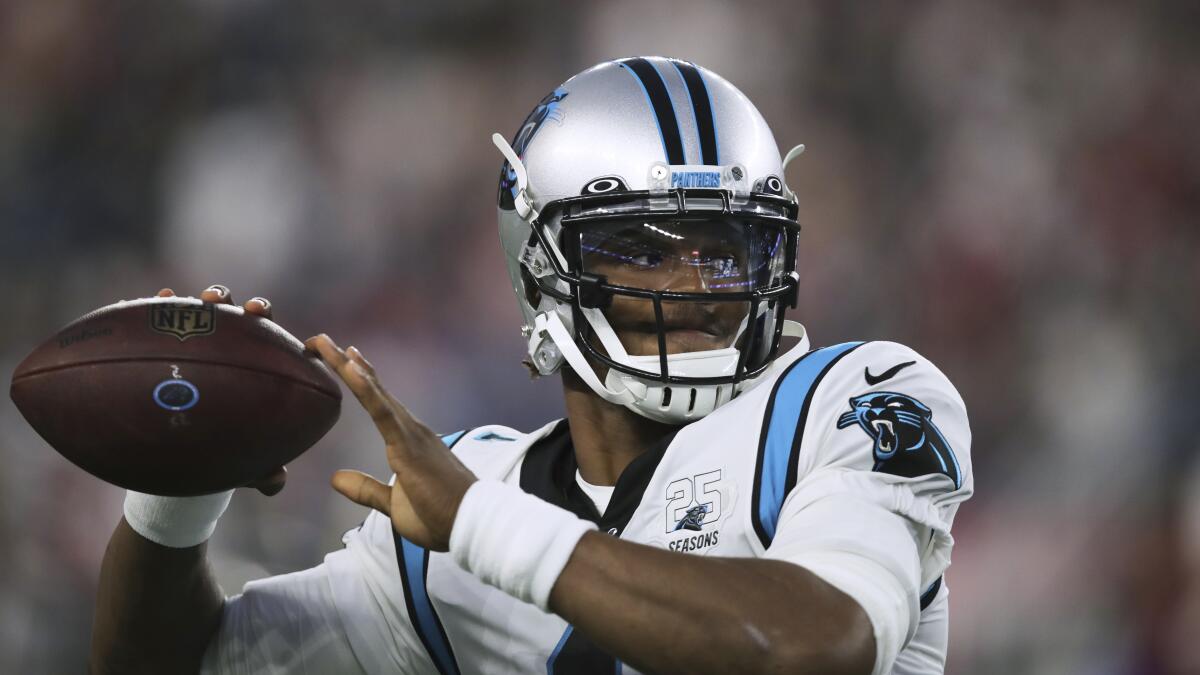 Cam Newton warms up before a Carolina Panthers preseason game.