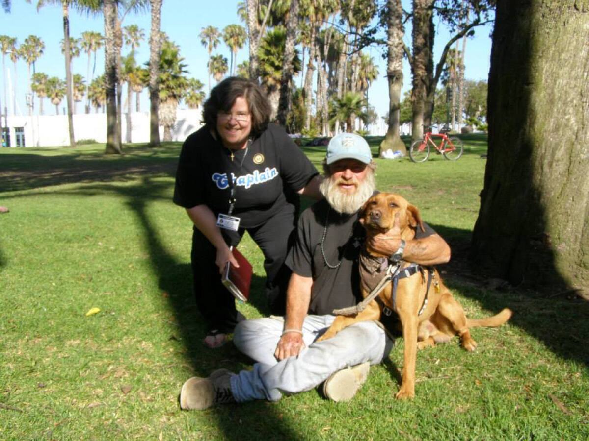 Hobo and Dreamer in the park with chaplain Kathy Davis.