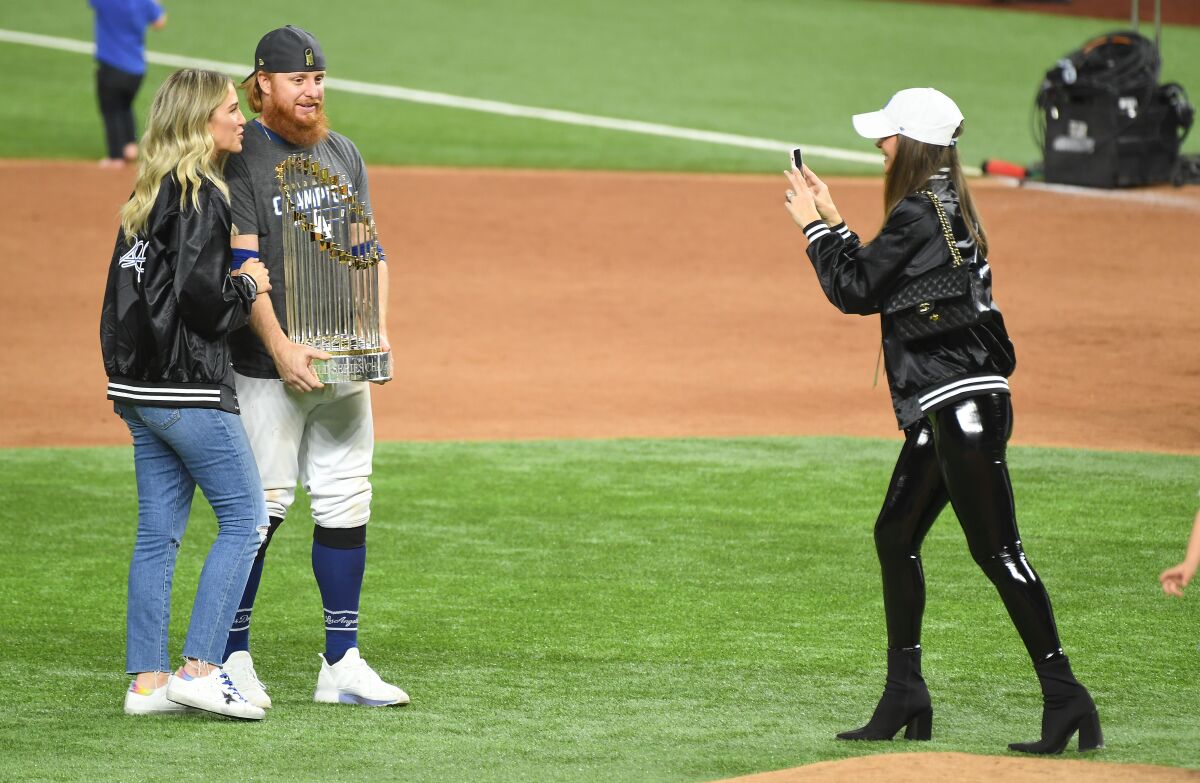 Justin Turner holds the Commissioner's Trophy next to his wife Kourtney Pogue after the Dodgers won the World Series.