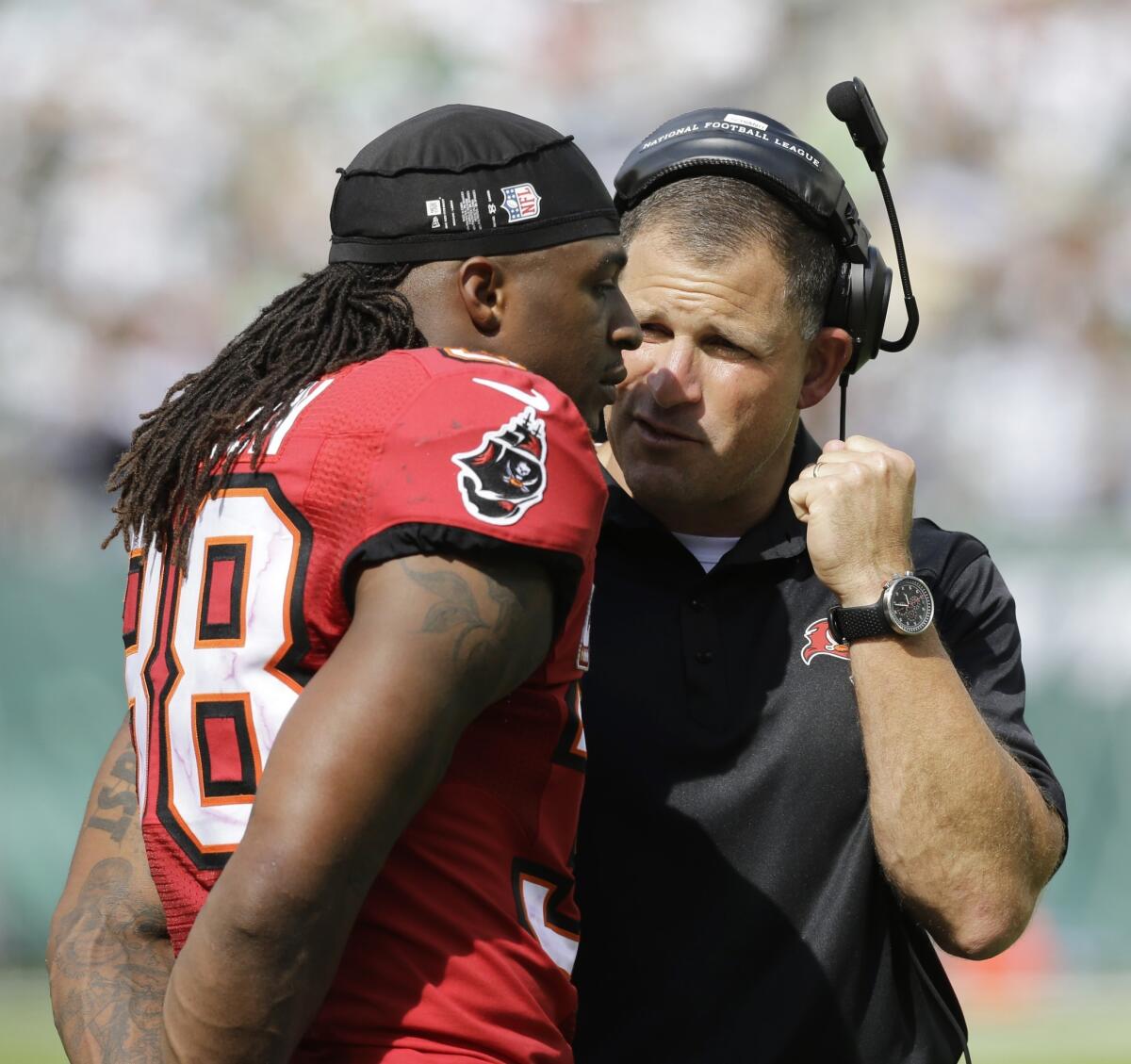 Dashon Goldson, left, speaks with Tampa Bay Buccaneers Coach Greg Schiano during a game against the New York Jets on Sept. 8.