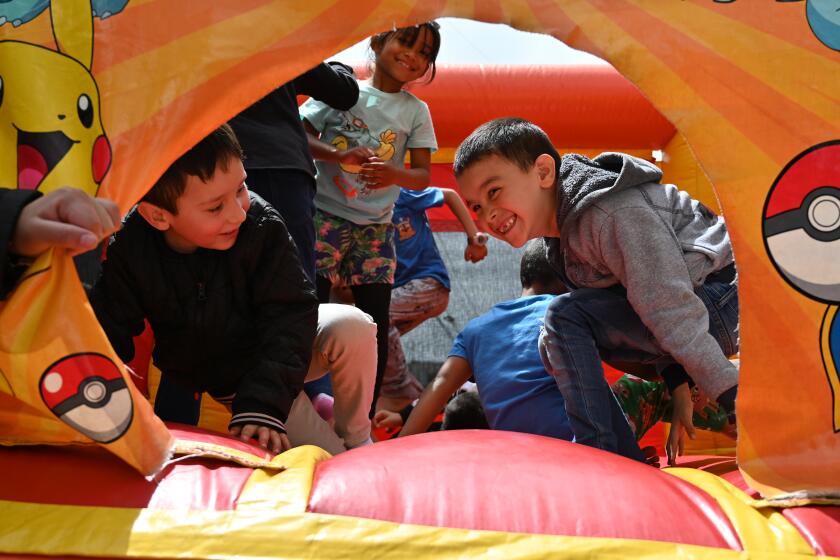 Migrants from the Joventud 2000 shelter near the US-Mexico border participated in a Children's Day event where picture booths and trampolines were set up for migrant children to enjoy and play in free of charge in Tijuana, Mexico on Friday, April 26, 2024. Children's Day has been celebrated in Mexico every April 30 since 1924 with the aim of promoting the well-being and rights of children and since then the date has become an occasion for recreational and educational activities, such as school events and festivals. (Carlos Moreno / The San Diego Union-Tribune)