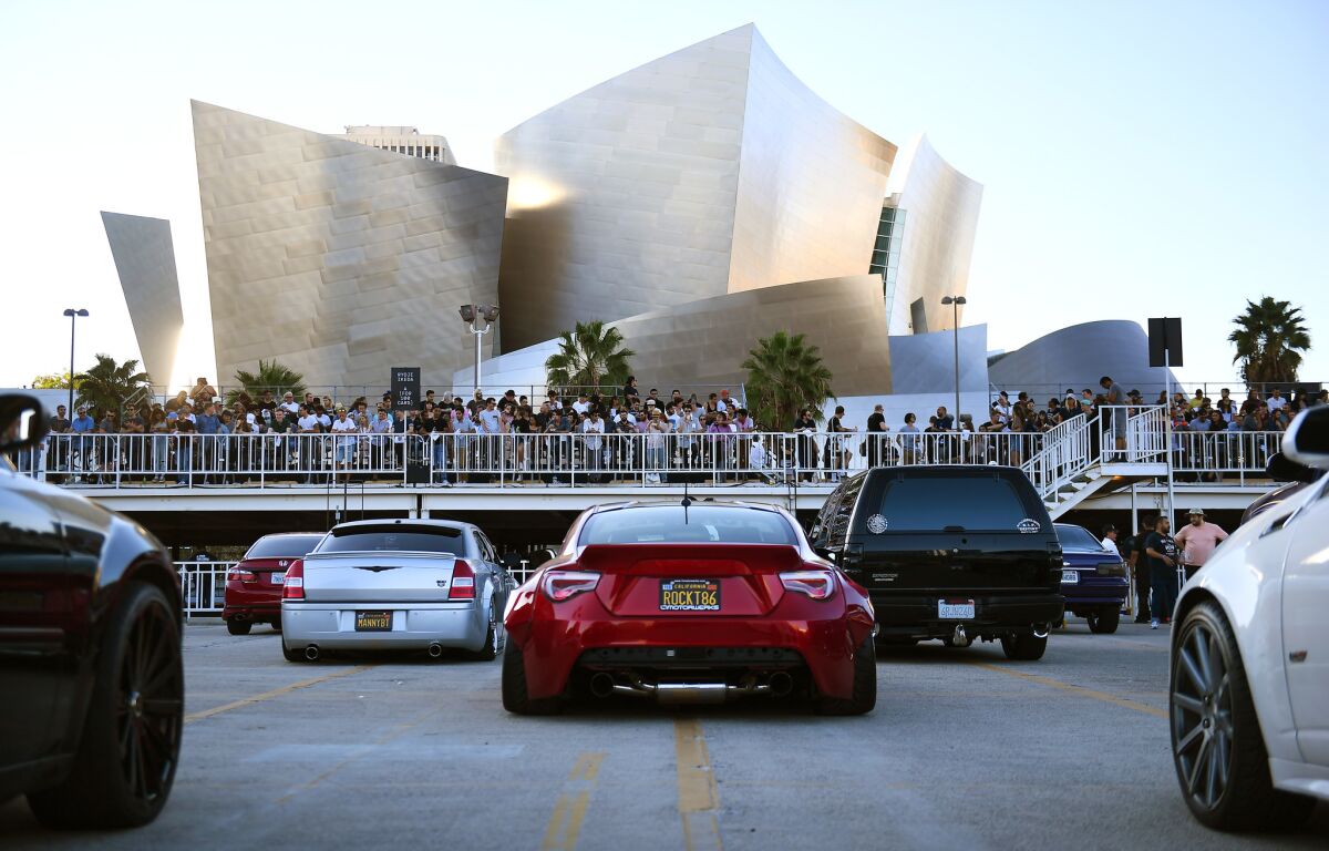 LOS ANGELES-CA-OCTOBER 15, 2017: Cars line up and a crowd awaits to witness renowned artist Ryoji Ikeda present a brand-new composition, in collaboration with 100 automobile owners, part of Red Bull Music Academy Festival Los Angeles, in downtown Los Angeles on Sunday, October 15, 2017. (Christina House / Los Angeles Times)