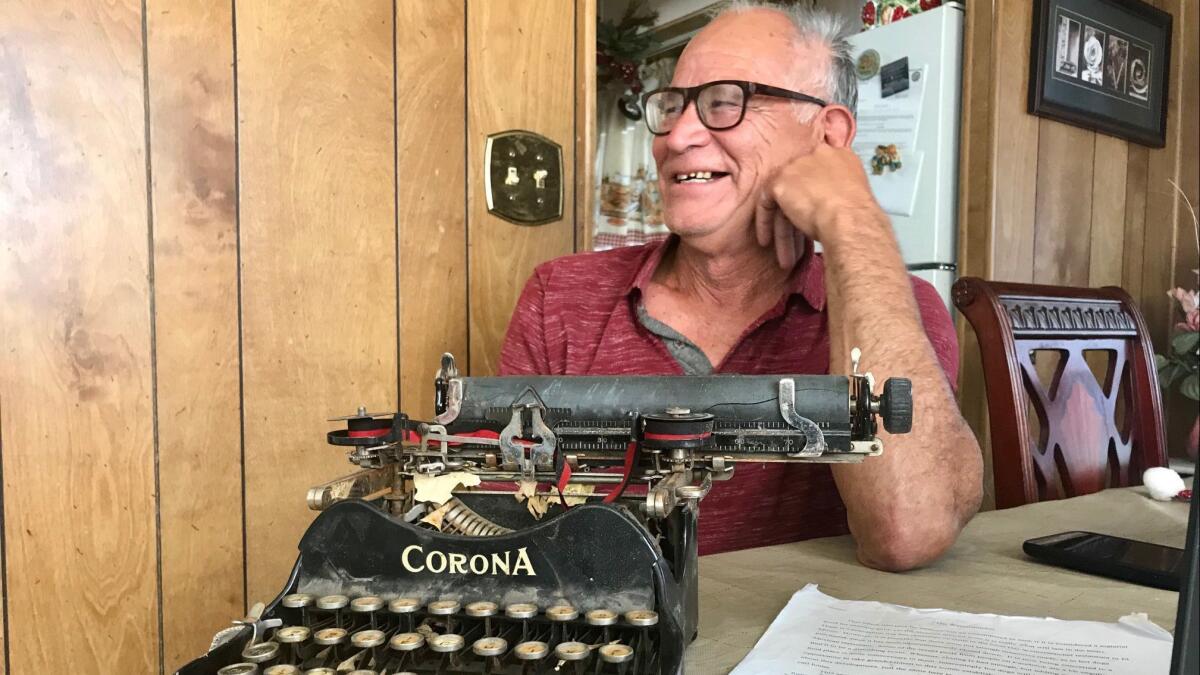 Jerry Valencia shows off an old Corona typewriter at his home.