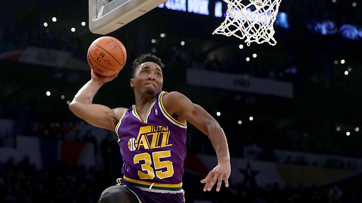 Utah guard Donovan Mitchell elevates along the baseline while performing during the Slam Dunk Contest on Saturday night at Staples Center.