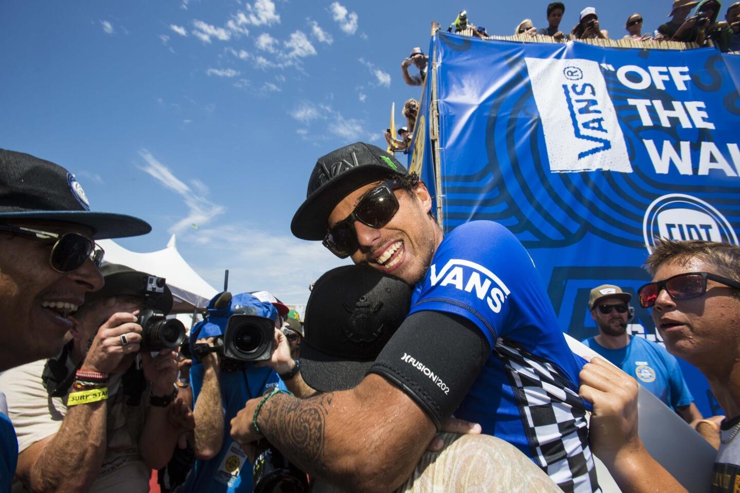Filipe Toledo celebrates with family and friends after winning the U.S. Open of Surfing men's championship on Sunday afternoon in Huntington Beach.