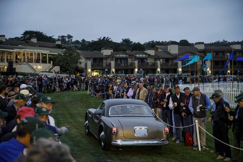 PEBBLE BEACH, CALIF. - AUGUST 18: People gather for "Dawn Patrol," were all the cars participating in the 69th Pebble Beach Concours d'Elegance roll out at the Pebble Beach golf course on Sunday, Aug. 18, 2019 in Pebble Beach, Calif. (Kent Nishimura / Los Angeles Times)