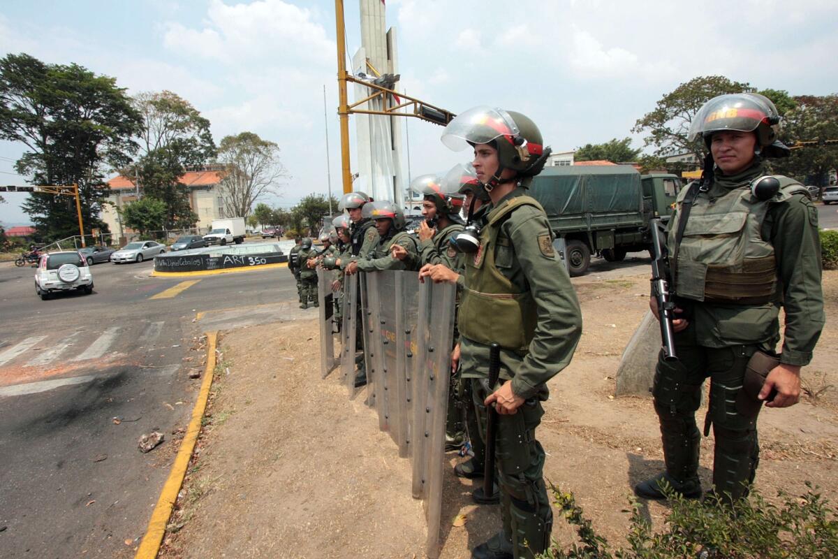 Security forces stand guard in the streets of San Cristobal, Venezuela, after barricades set up by antigovernment demonstrators were cleared. Protests driven in part by food shortages have roiled Venezuela for two months.