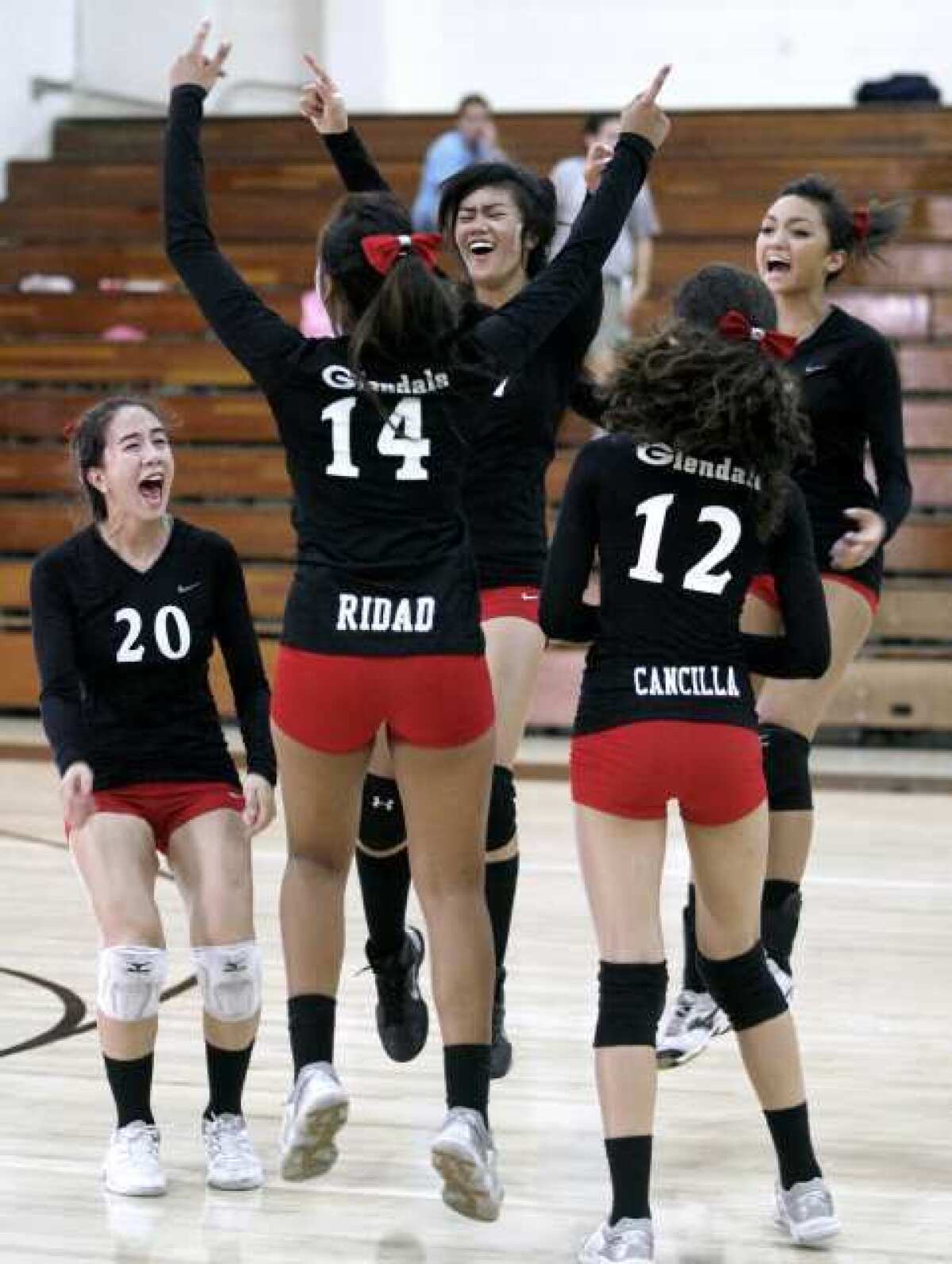 The Glendale High School girls' volleyball team celebrates their win over rival Crescenta Valley.