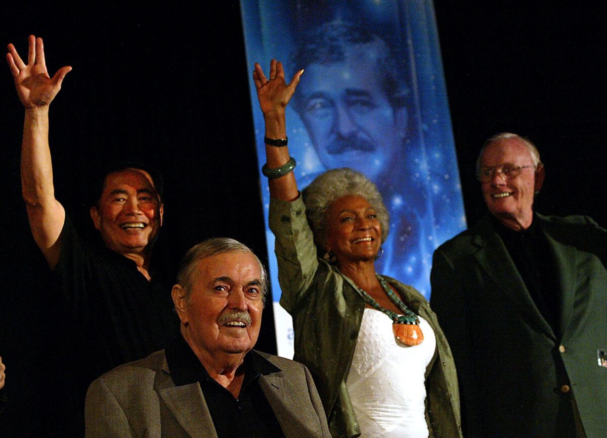 George Takei, left, the late James Doohan, Nichelle Nichols and the late Neil Armstrong are shown in 2004 at a "Star Trek" convention.