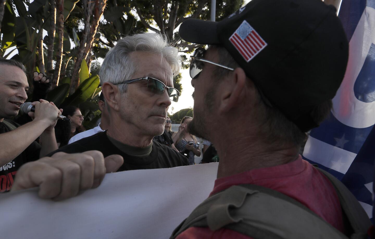 BEVERLY HILLS, CALIF. - SEP. 17, 2019. A supporter of President Donald Trump, right, goes face to face with anti-Trump protesters at the intersection of Sunset Boulevard and Benedict Canyon Road in Beverly Hills on Tuesday, Sept. 17, 2019. As the factions clashed, Trump attended a fundraiser nearnby at the home of real estate developer Geoff Palmers. (Luis Sinco/Los Angeles Times)