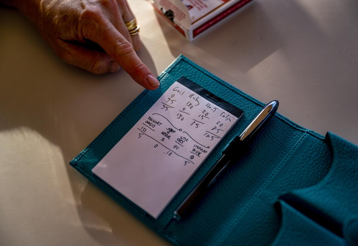 Colin Campbell and his wife, Gail, still keep the score card with their names and their children's from a card game.