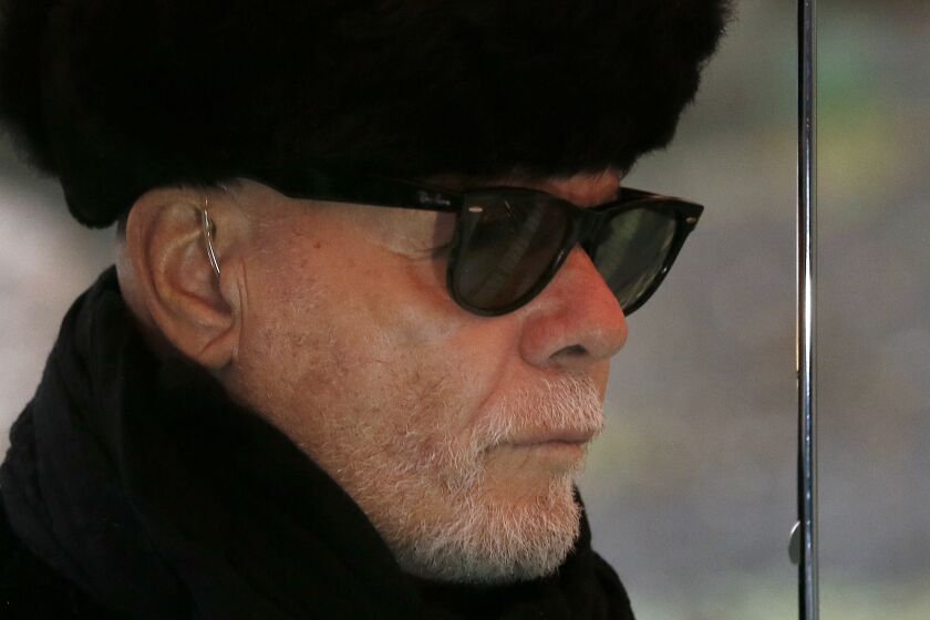 British pop star Gary Glitter, real name Paul Gadd, arrives at Southwark Crown Court in London, Thursday, Feb. 5, 2015. The jury went out Wednesday to consider their verdict. Gadd is facing historic sex abuse charges dating back to the 1970s. (AP Photo/Kirsty Wigglesworth)