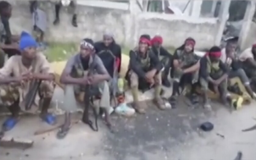 In this image taken from militant video released by the Islamic State group on Monday March 29, 2021, purporting to show fighters near the strategic north eastern Mozambique town of Palma, as the militant group claimed it had taken control of the area after five days of conflict. The video from the Islamic State group claims to show fighters in or near Palma, but cannot be independently verified by The Associated Press. (AMAQ Militant video via AP)