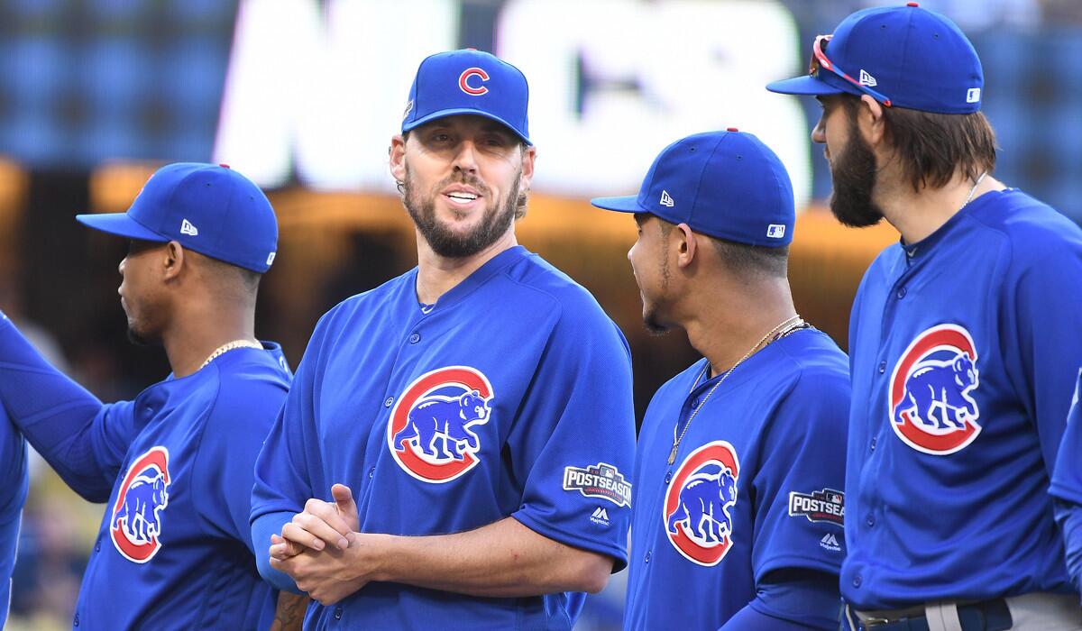 Chicago Cubs pitcher John Lackey, second from left, laughs during introductions for Game 3 of the National League Championship Series at Dodger Stadium on Tuesday.