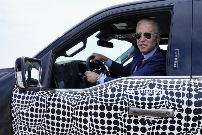 President Joe Biden stops to talk to the media as he drives a Ford F-150 Lightning truck at Ford Dearborn Development Center, Tuesday, May 18, 2021, in Dearborn, Mich. (AP Photo/Evan Vucci)