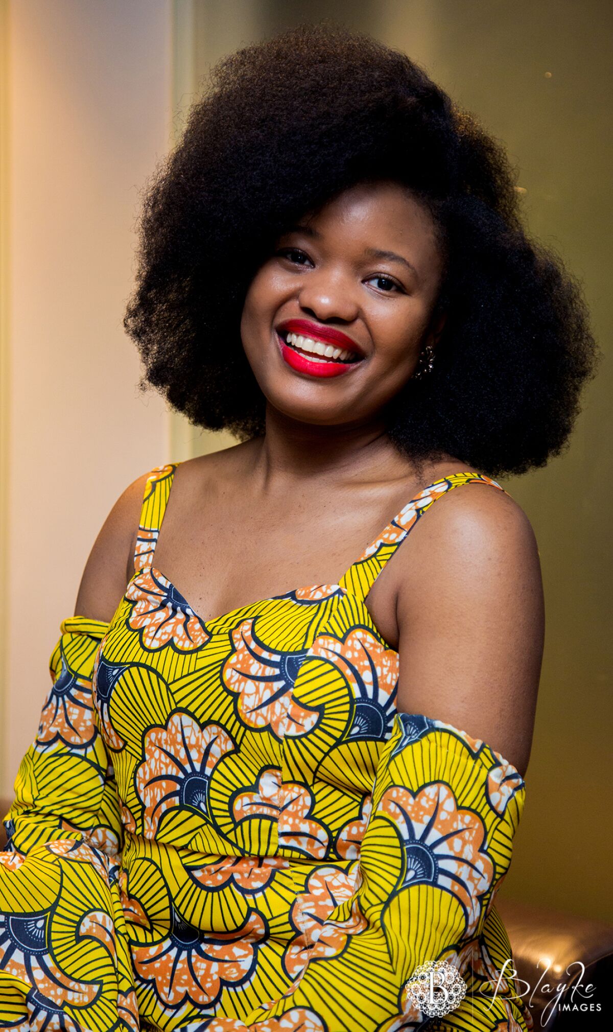 Portrait of a young woman wearing a bright African print.