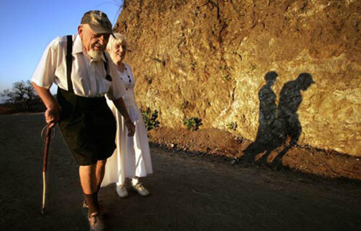 Sol Shankman, 93, and his companion, Anneliese Clay, 81, walk along Griffith Park's Riverside Trail, east of the Greek Theatre. He began hiking in the park in 1976 after suffering from angina. At first, it was principally therapeutic, he says. But I just kept on walking. Shankman has been walking pretty much every day since then  42,000 miles, by his reckoning,