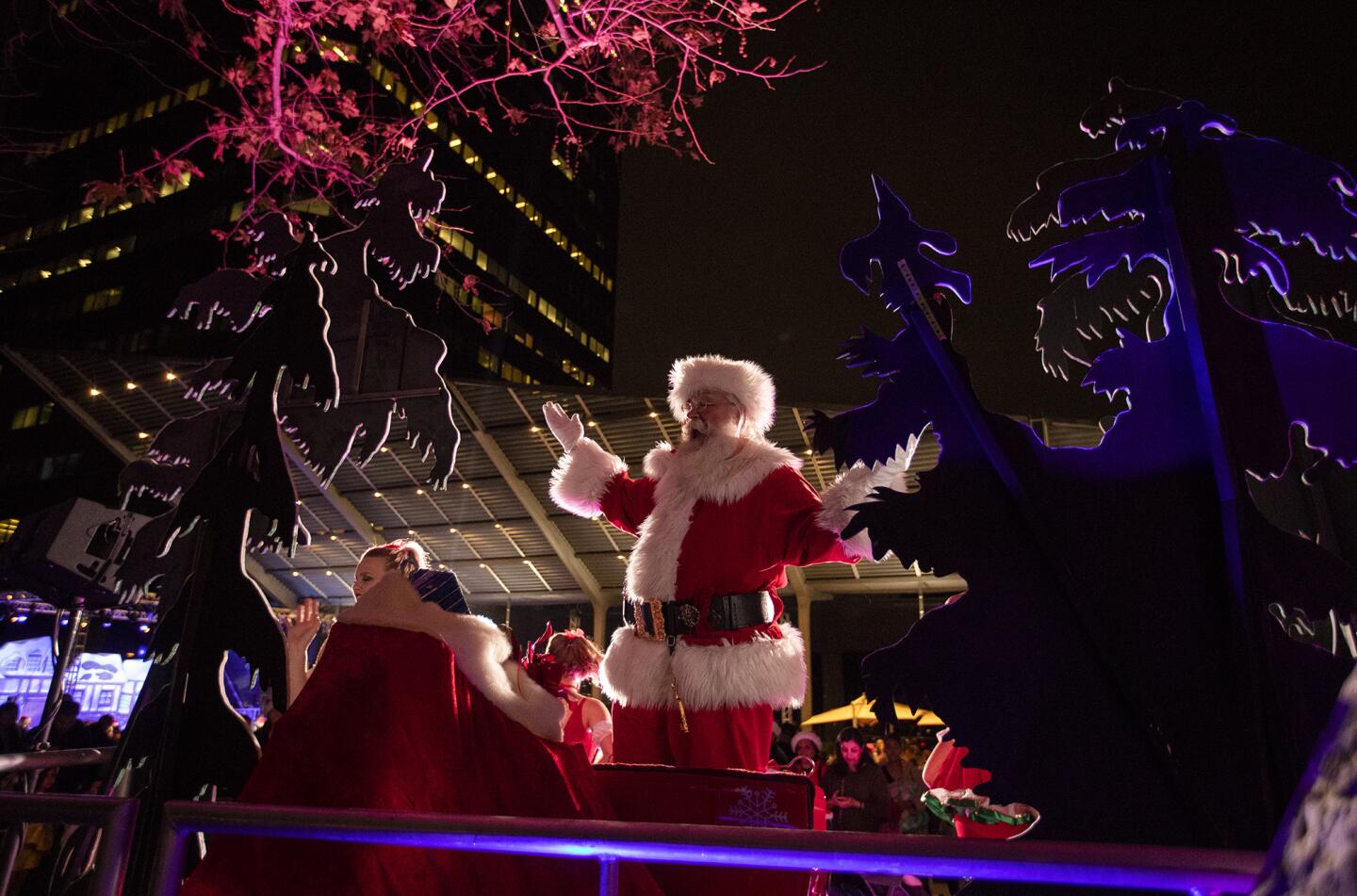 Santa Claus waves to the crowd during the annual South Coast Plaza tree lighting ceremony on Thursday, November 15.