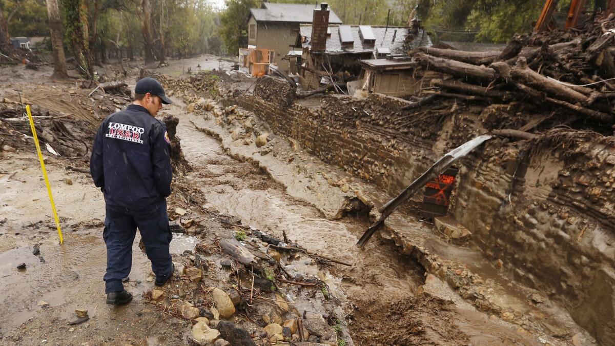 Lompoc firefighter Chris Martinez, an urban search-and-rescue team member, scouts Montecito Creek on Wednesday.