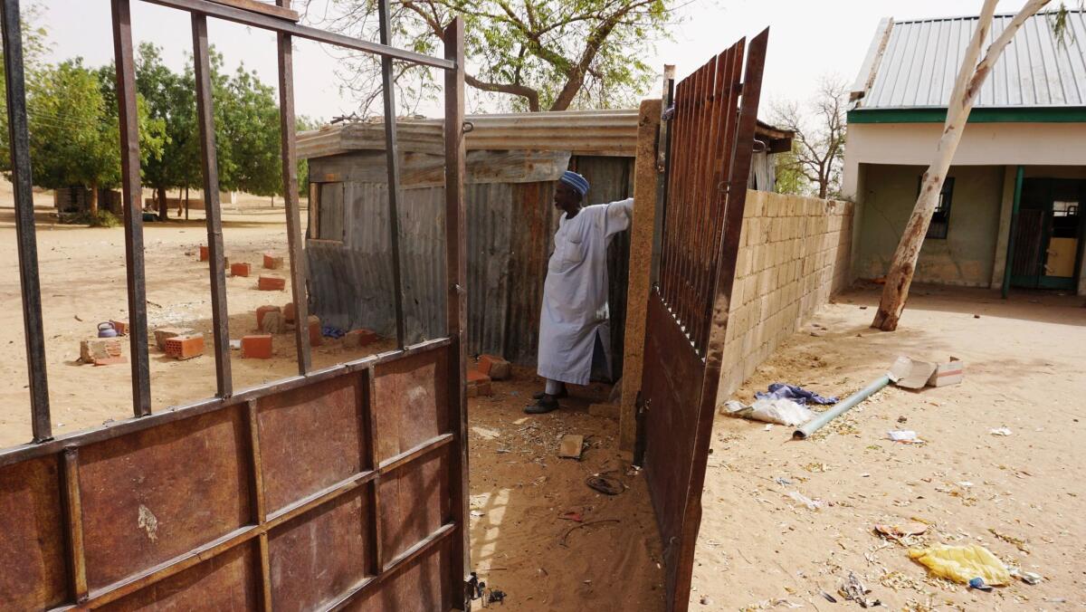 A watchman stands at the gate of the Government Girls Technical College in Dapchi, Nigeria. Boko Haram attacked the school Feb. 19.