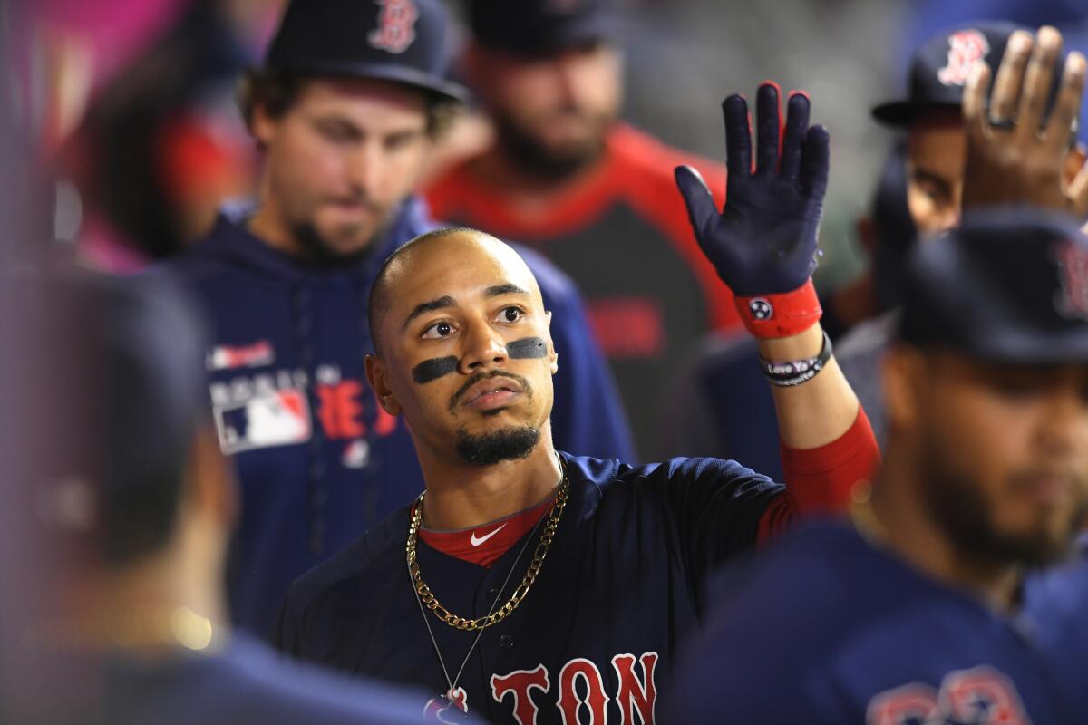 Mookie Betts celebrates with his Boston Red Sox teammates after hitting a solo home run against the Angels on Aug. 30.