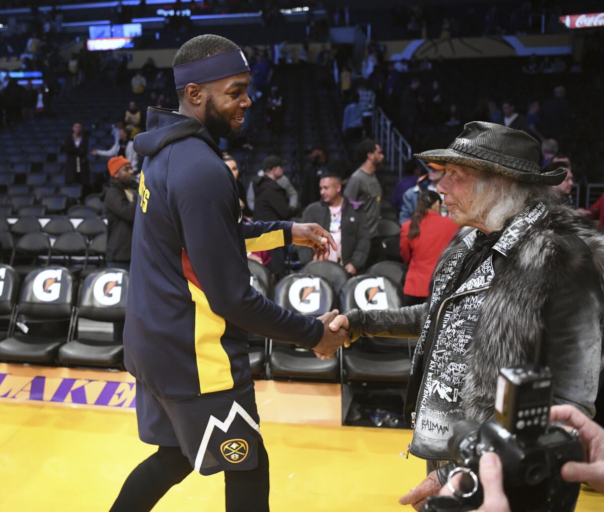 James Goldstein shakes hands with Denver Nuggets forward Paul Millsap in 2019