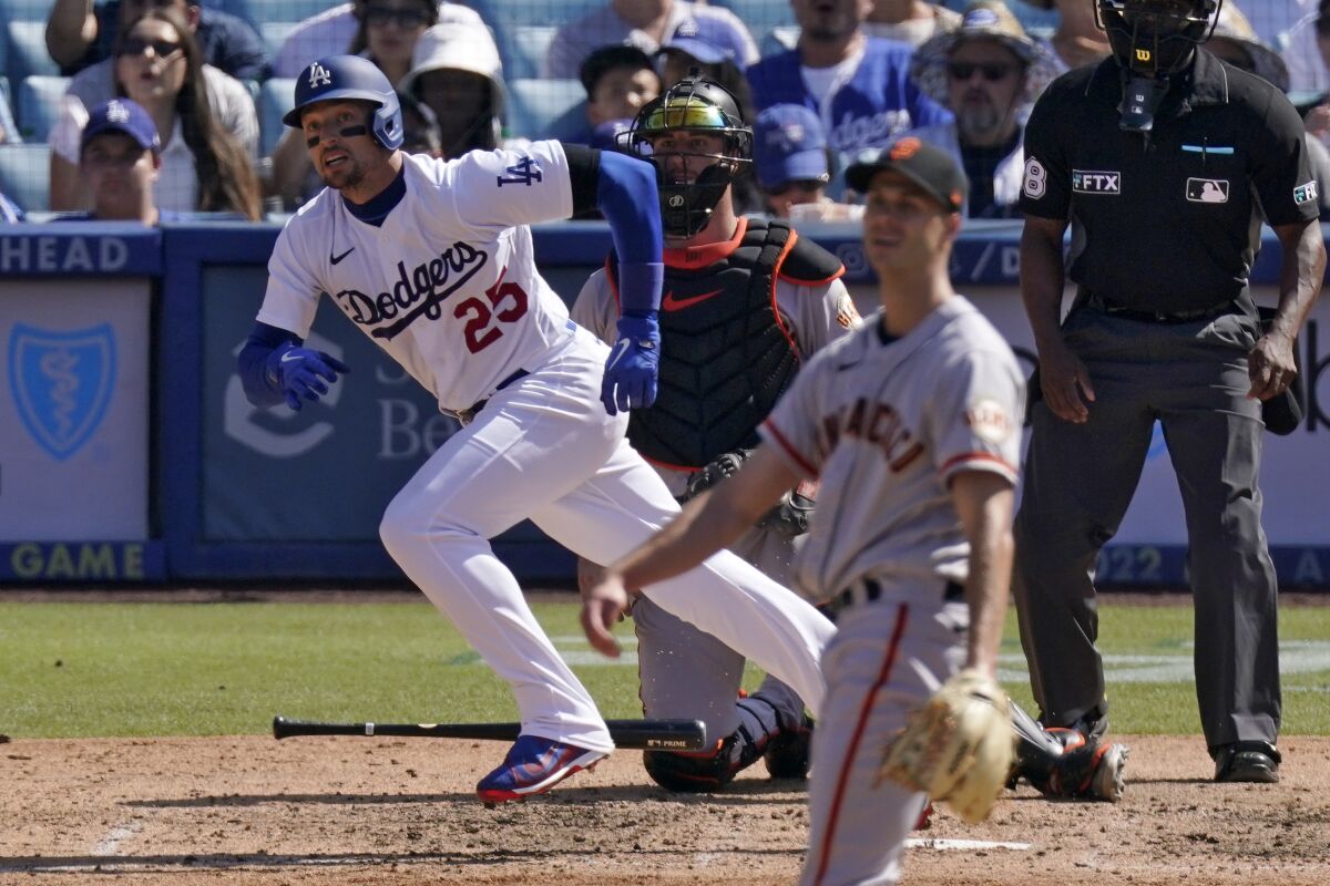Trayce Thompson, left, runs to first after hitting a run-scoring double.