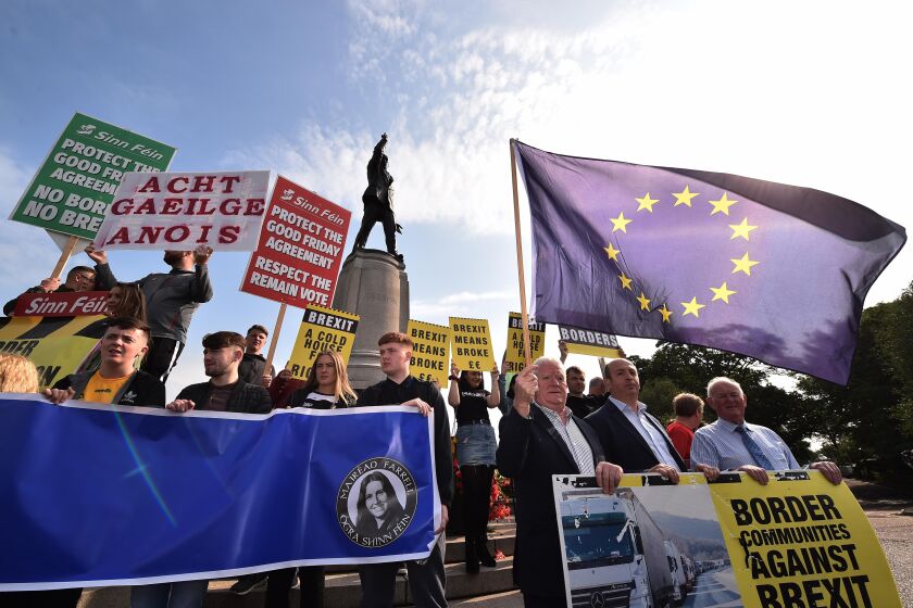 Brexit demonstrators gather as British Prime Minister Boris Johnson visits Stormont, the seat of government in Belfast, Northern Ireland, on July 31, 2019.