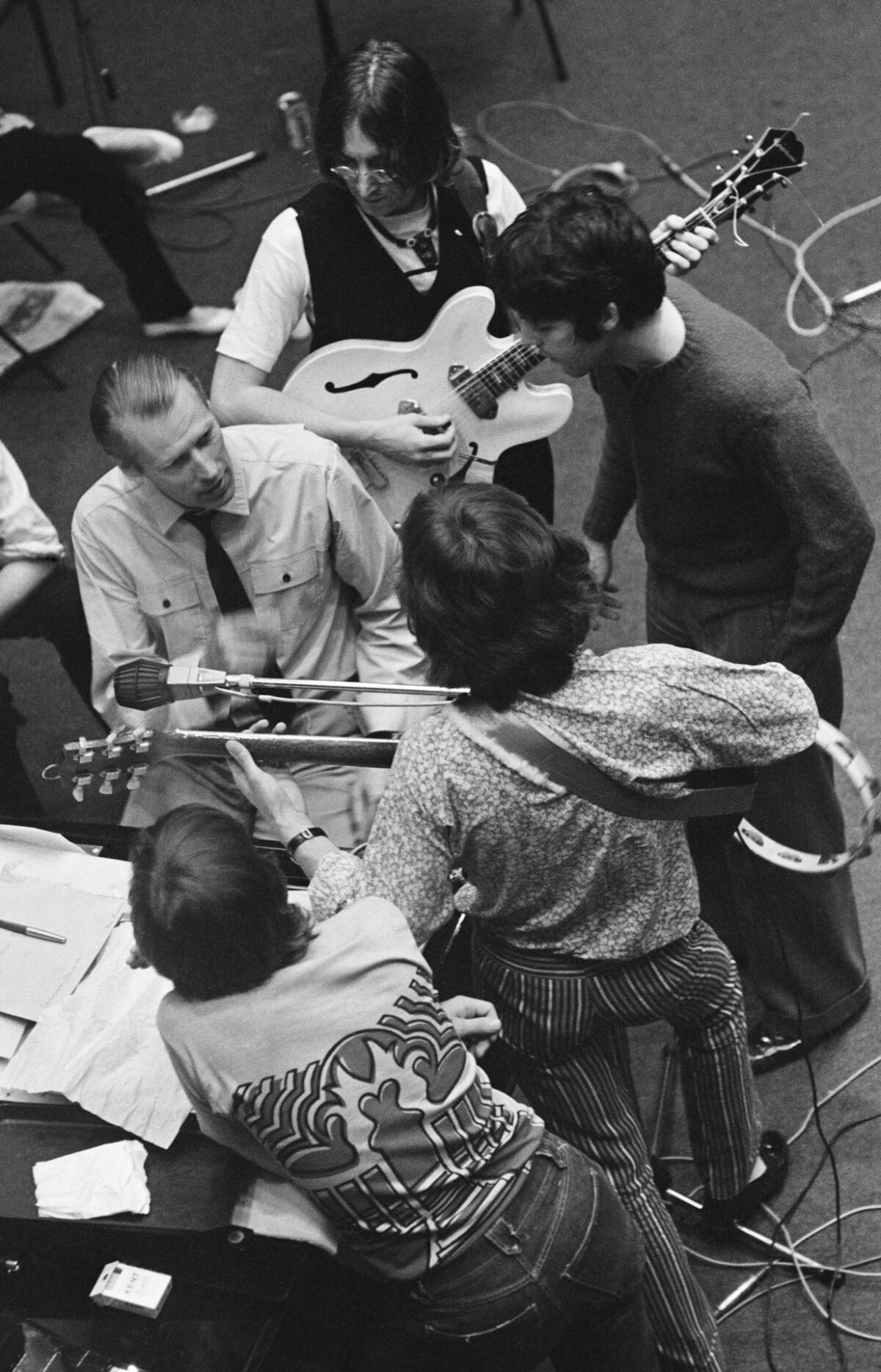 The Beatles with George Martin during a recording session at Trident Studios in 1968.