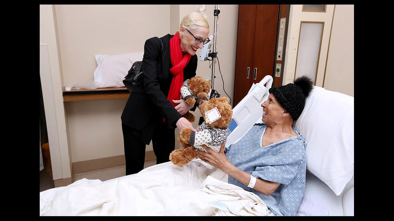 Bloomingdale's Glendale general manager Courtney Saavedra, left, gives oncology patient Maria Ramona Pereira a stuffed bear for the annual Project Hug-A-Bear at Adventist Health Glendale, on Friday, Dec. 21, 2018. About 60 bears, half donated by two foundation donors and the balance matched by Bloomingdale's, will be given to patients this year.