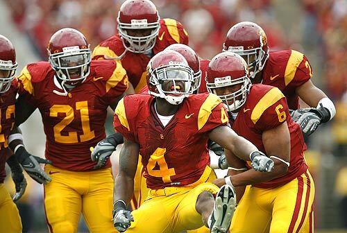 USC's Joe McKnight (4) celebrates his 45-yard punt return Saturday, which set up the Trojans' go-ahead touchdown in their 20-13 victory over the Arizona. In addition to his big fourth-quarter return, McKnight had a 59-yard run from scrimmage that set up a field goal late in the game.