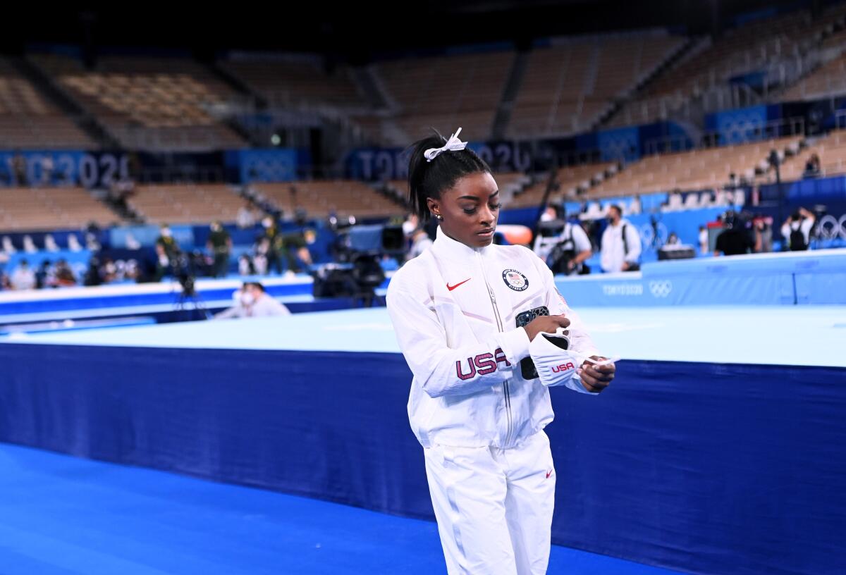 Simone Biles walks alone after the women's team final at the Tokyo Olympics on Tuesday.