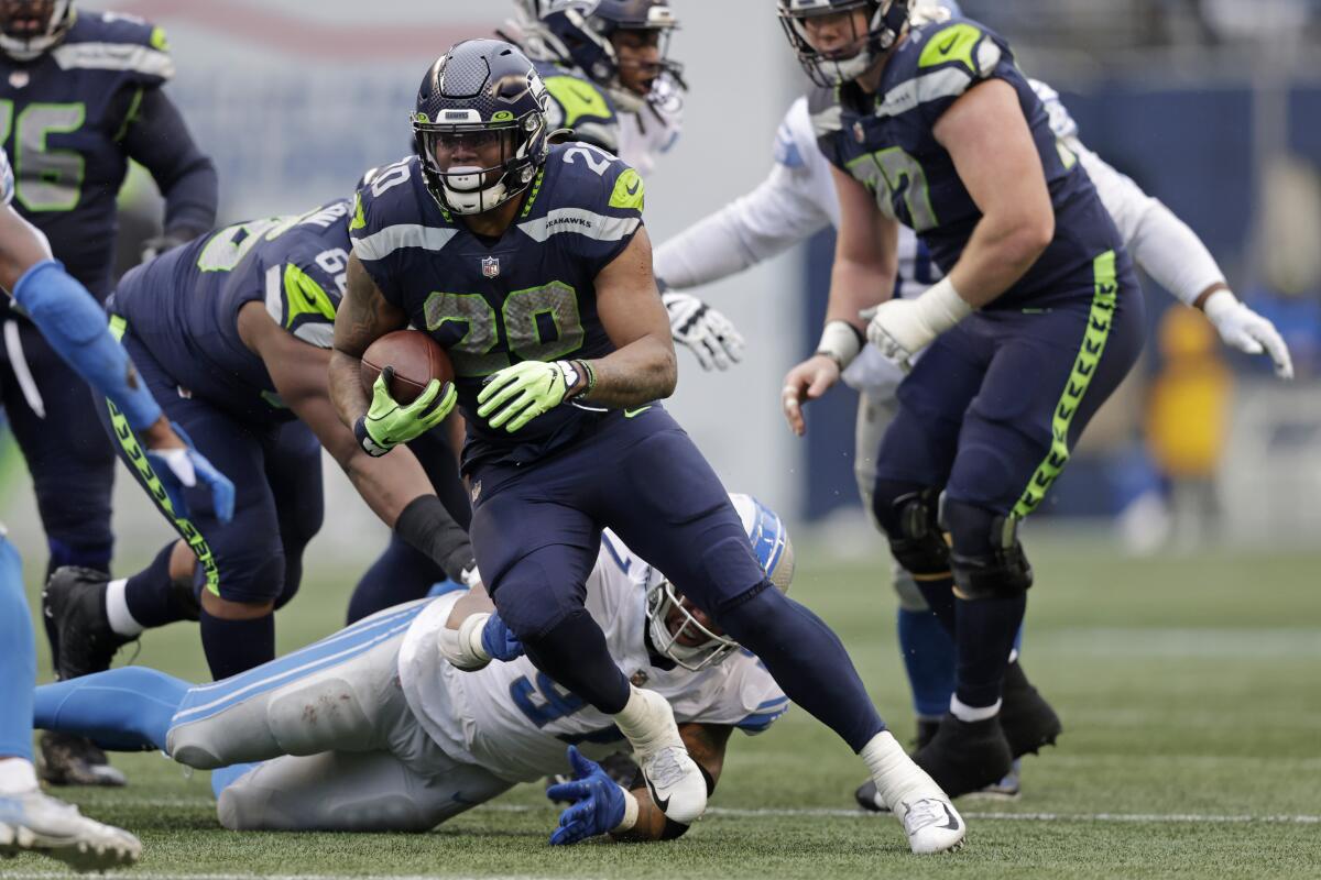 Seattle Seahawks running back Rashaad Penny carries the ball against the Detroit Lions.