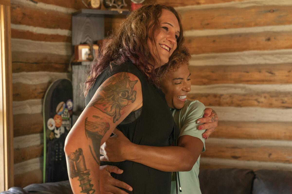 Two people hug in HBO's "We're Here."