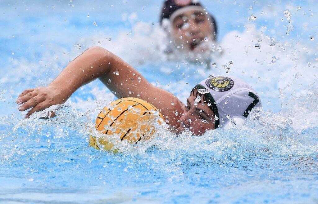 Costa Mesa Aquatics Club's Tate Kallman, bottom, steals the ball away from Los Angeles Water Polo Club's Cole Kaplan, top, during a USA Junior Olympics semifinal match at Mater Dei High in Santa Ana on Tuesday.