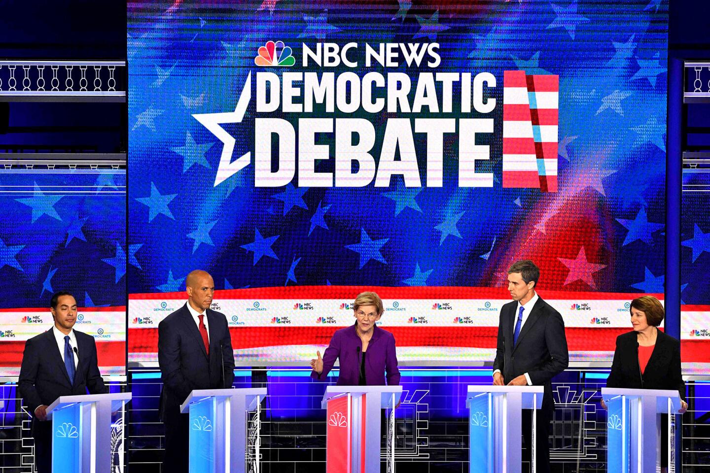 Elizabeth Warren, center, answers a question as Julián Castro, Cory Booker, Beto O'Rourke and Amy Klobuchar, from left, wait for their turns.