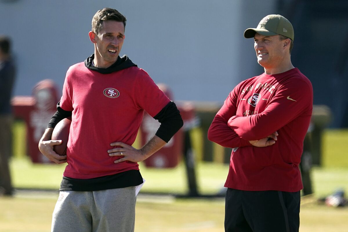 San Francisco 49ers coach Kyle Shanahan, left, and general manager John Lynch talk during a team practice.