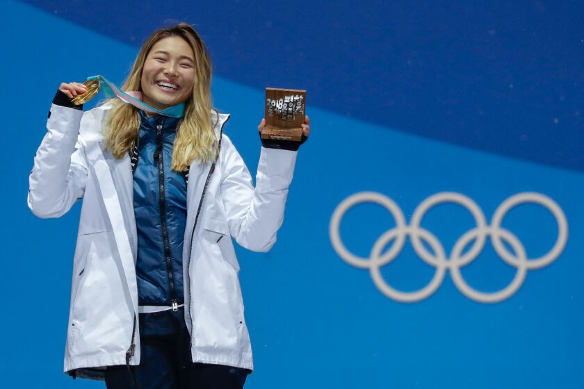 Women's halfpipe gold medalist Chloe Kim poses during the medals ceremony at the 2018 Winter Olympics