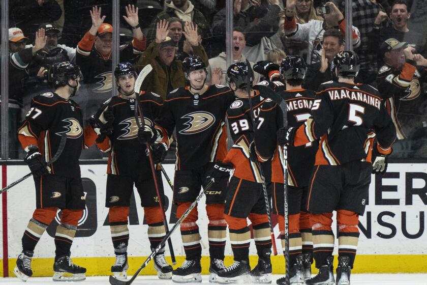 Anaheim Ducks celebrate a 5-4 overtime win over the San Jose Sharks in an NHL hockey game.