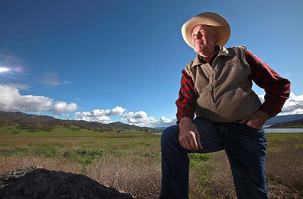 John Ahmann, standing on his land near Lake Berryessa where he runs cattle, has decided with his wife, Judy, to place 3,000 acres of land into a conservation easement that they hope will become part of the proposed Berryessa Snow Mountain National Conservation Area.