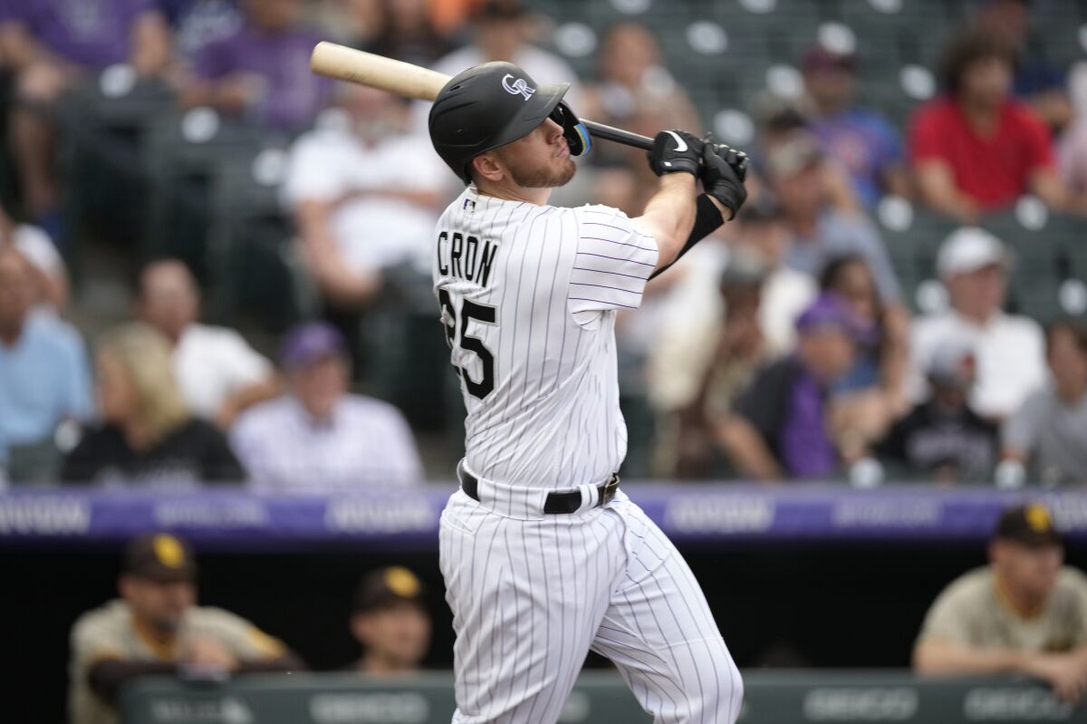 Colorado Rockies' C.J. Cron watches his two-run home run off San Diego Padres starting pitcher MacKenzie Gore during the first inning of a baseball game Friday, June 17, 2022, in Denver. (AP Photo/David Zalubowski)