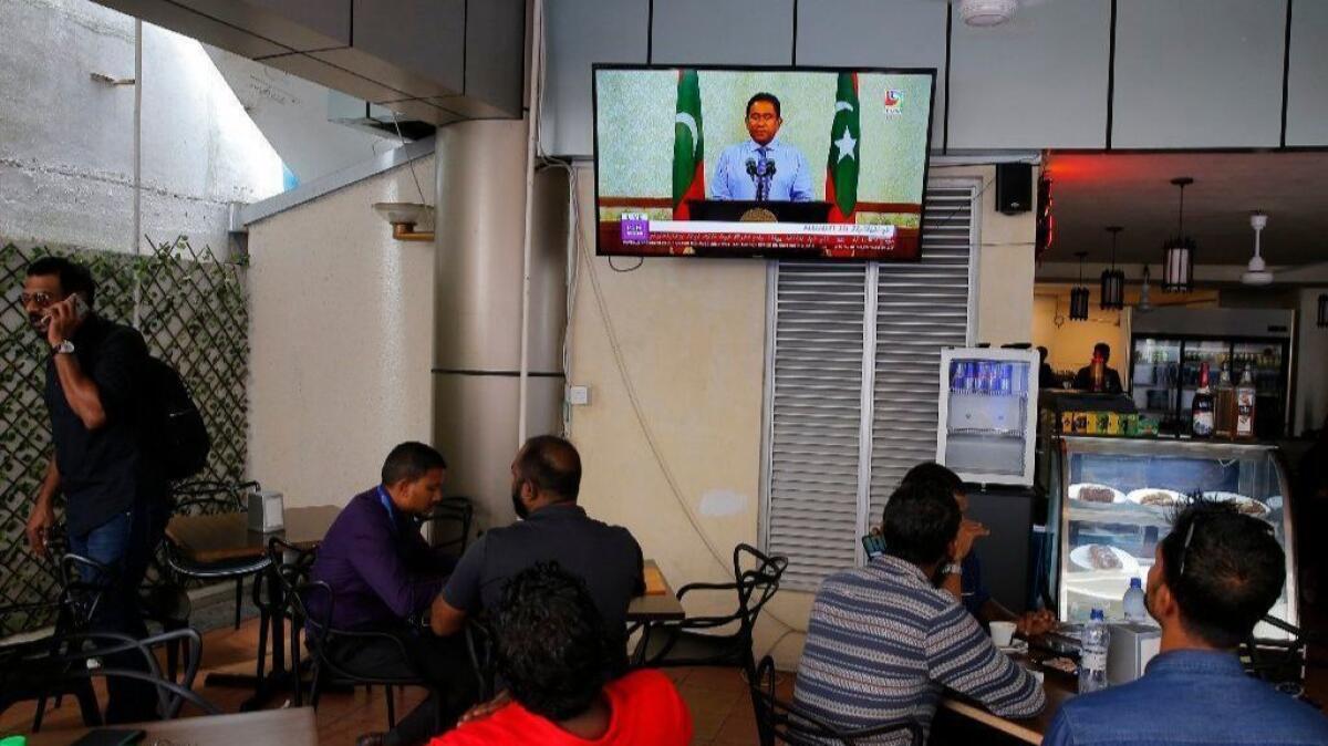 Maldivians watch a live telecast of a concession speech delivered by President Abdulla Yameen Abdul Gayoom at a cafe in Male, Maldives on Sept. 24.