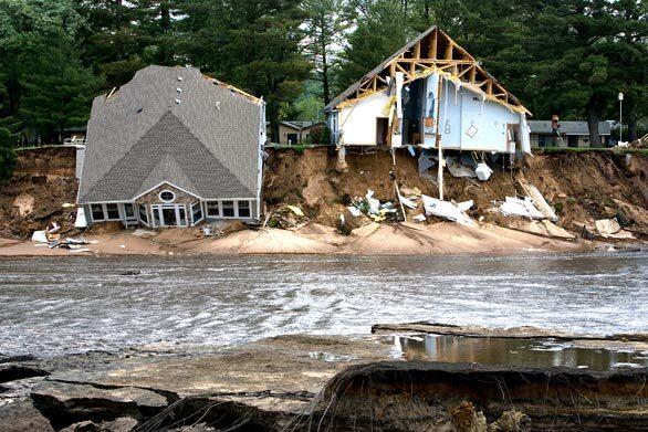 Two houses fall into Lake Delton in central Wisconsin after the 267-acre lake overflowed.