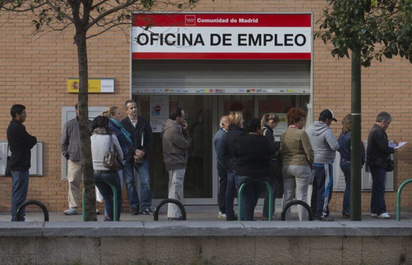 Unemployment in the 17 countries that share the euro is higher than 11%, and it's still heading up. Above: People wait in line outside an unemployment office in Madrid, Spain.